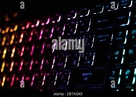 Colorful modern keyboard with rainbow backlight on black background. Backlight of the keyboard in different colors Stock Photo