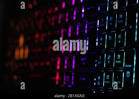 Colorful modern keyboard with rainbow backlight on black background. Backlight of the keyboard in different colors Stock Photo