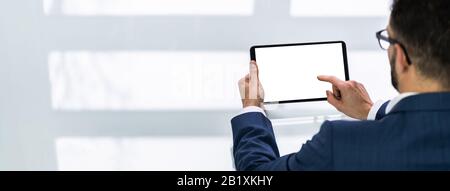 Close-up Of Businessman Looking At Digital Tablet Stock Photo