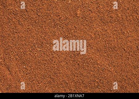 Ground Cinnamon texture, full frame background.  As a spice or condiment cinnamon sold in the form of sticks or a hammer. Used as a spice in cuisines Stock Photo