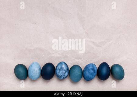Minimalistic background. Golden eggs are arranged in a straight line. Stock Photo