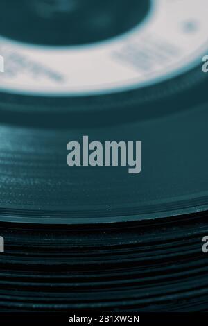 Vinyl records stacked on top of each other in a pile.  With colour toning Stock Photo
