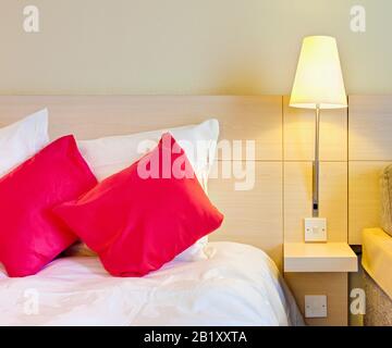 Hotel room, bed with close up of bedside table Stock Photo