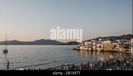 Hora, Mykonos - September 23, 2019:  People watching sunset over the old houses in Little Venice, Hora (Mykonos Town), capital of the island and one o Stock Photo