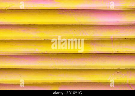 Background and texture of metal gates in yellow and pink colors. Close up. Stock Photo