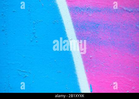 Abstract metal texture with a spray can of blue, pink and white line paint. Close up. Stock Photo