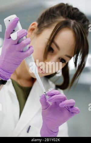 Production technician Jade Procter, makes synthetic rda, part of the Coronavirus COVID-19 detection kit, at the Primerdesign offices and labs at Chand Stock Photo