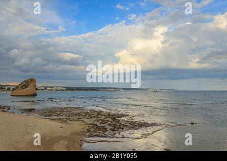 Salento coast: Torre Pali beach (Lecce). ITALY (Apulia).The low sandy coastline is charactherized by dunes covered with Mediterranean scrub. Stock Photo