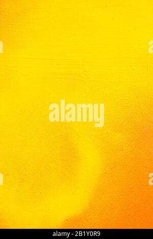Abstract metal texture by spray can of paint. Gradient in orange, yellow. Vertical. Close up. Stock Photo