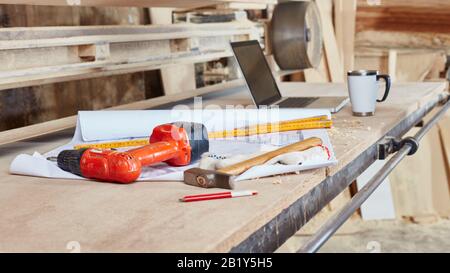 Blueprint with tools is on the workbench in a joinery Stock Photo