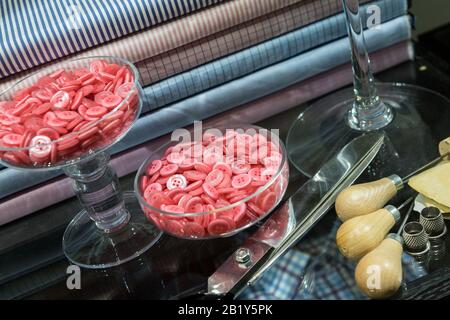 Tailor's Table with Assorted Implements including awl, thimbles, buttons and chalk Stock Photo