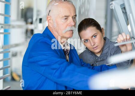 man and woman in steel factory Stock Photo