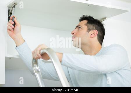 man assembling of furniture Stock Photo