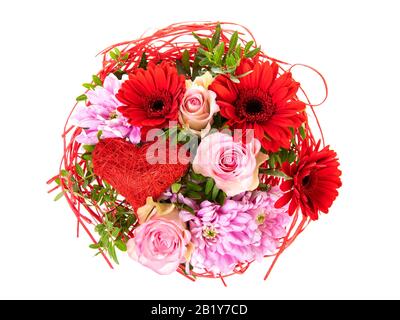 Flower bouquet with pink roses, red gerber and purple aster blossoms and heart-shaped ornament, high angle view, isolated on white background Stock Photo
