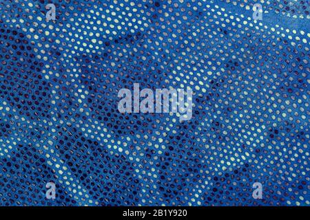 Snakeskin pattern on genuine leather close-up, imitation of exotic reptile, surface of bright blue color, trendy background. Stock Photo