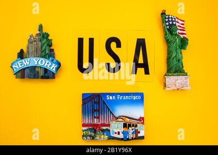word USA with magnets from new york and san francisco on yellow background, travel destination, America travel Stock Photo