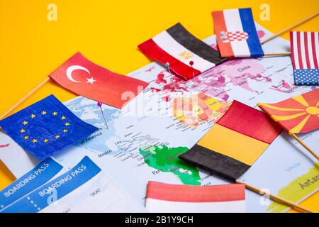 Flags from different countries and boarding pass over world map, Planning trip, travel concept Stock Photo