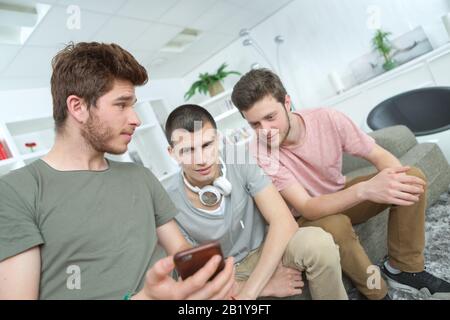 guy getting together and watching funny stuff on the internet Stock Photo