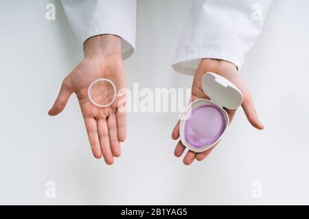 Gynecologist Showing Contraception Ring And Diaphragm To Woman And Explaining Contraception And Birth Control Stock Photo