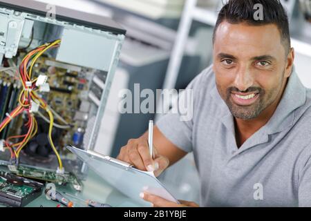 a male technician fixing cables Stock Photo