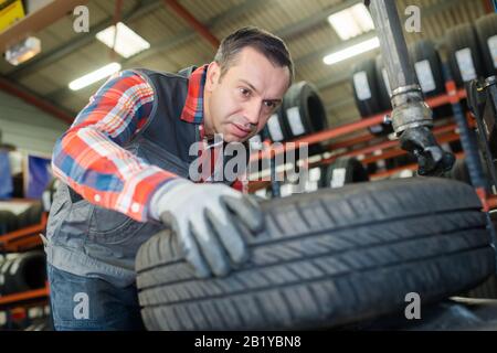 garage man working with tyres Stock Photo