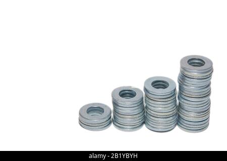 Metal round washers with holes folded into stacks isolated on white background with copyspace. Stock Photo