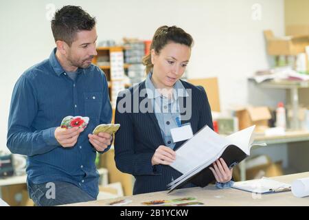 make customer picking an appropriate design for his ads Stock Photo