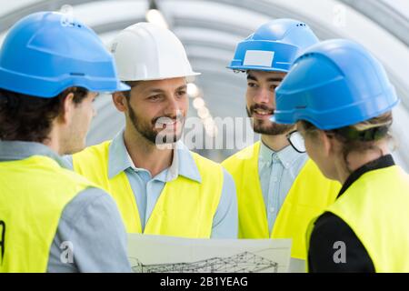 four engineers discussing about a new project Stock Photo