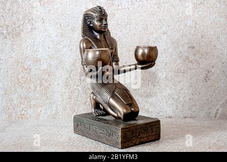 Amenhotep II offering two glasses of wine to a god, statue Stock Photo