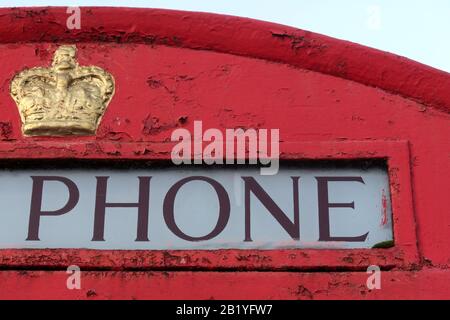 Red British Telephone Box 'Phone' with gold ER crown - K6 public telephone designed by Sir Giles Gilbert Scott Stock Photo