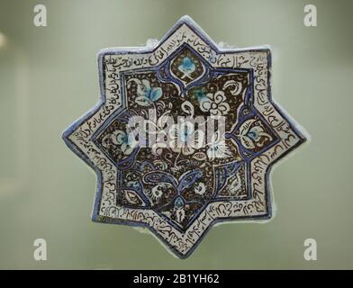 Tiles. Lustre technique glazed. 8 pointed star. Ilkhanid period. Kashan, Iran. 13th cent. Istanbul Archaeology Museums. Museum of Islamic Art. Stock Photo