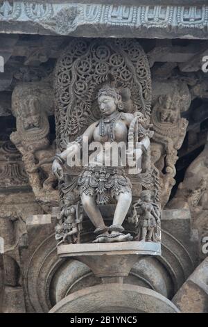 Madanika with a bow, celestial maiden on pillar Chennakeshava Temple, Belur, Karnataka, India Stock Photo
