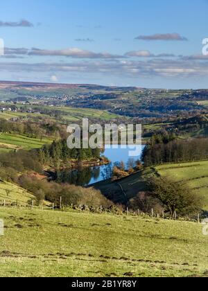 Scenic sunny Lower Laithe Reservoir (upland villages, cottages, valley slopes, hilly farmland fields, moors) - Haworth Moor, West Yorkshire England UK Stock Photo