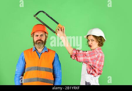 couple is renovating home. couple doing apartment repair together themselves. man and woman wear safety helmet. couple at the construction site. couple making repairs to their home. Home Renovation. Stock Photo