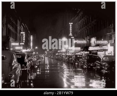 NEW YORK 1940’s Retro B&W wet reflections night clubs neon signs restaurants clubs 52nd Street, New York, USA  1948 Stock Photo