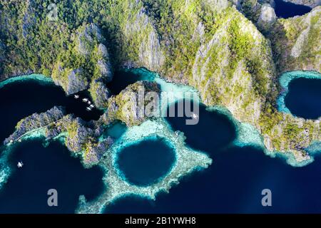 View from above, stunning aerial view of the Twin Lagoons surrounded by rocky cliffs. The Twin Lagoons are one of the must-see destinations in Coron. Stock Photo