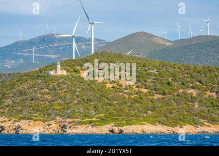 Greece. Hilly coast of the Gulf of Corinth in sunny day. Many wind farms and old lighthouse building Stock Photo