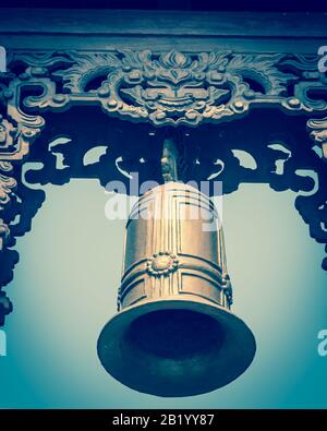 Typical bell tower outdoor instrument, ancient bell and gazebo in the pagoda in Vietnam Stock Photo