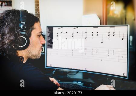 songwriting man occupation writing music in vintage vignette background artistic occupation Stock Photo