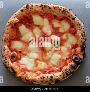 classic soft Neapolitan pizza, low in the middle with the cord, stuffed oregano Stock Photo