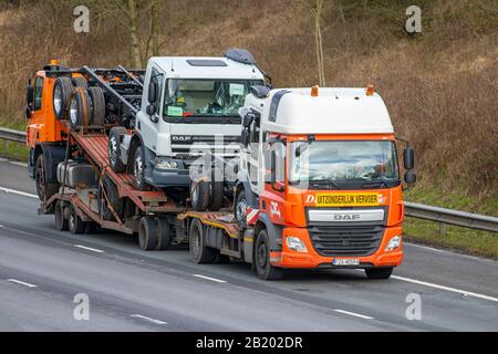 Convoi Exceptional Volvo truck; Motorway heavy loads, bulk Haulage new DAF delivery trucks, lorry, transportation, wide load delivery, transport, industry, oversize freight on the M6 at Lancaster, UK Stock Photo