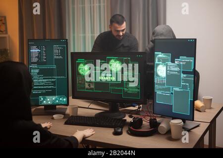 Happy female cyber terrorist after hacking a firewall and gets access granted. Cyber terrorists. Stock Photo