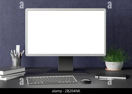 Workspace with blank computer monitor white screen mock up on the dark desk near blue wall Stock Photo