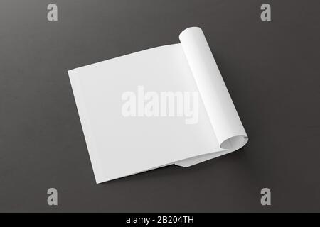 Blank square left magazine page. Workspace with folded magazine mock up on black desk. Side view Stock Photo
