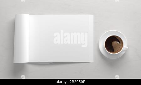 Blank horizontal right magazine page. Workspace with folded magazine mock up on white desk with cup of coffee. View above Stock Photo