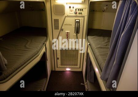 Cabin crew rest area on board the modern Airbus A350. Bunker area with ...