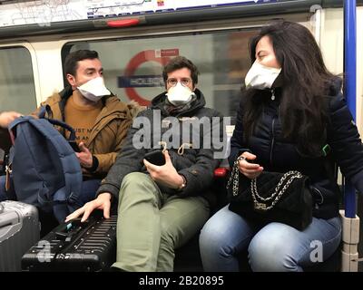People wearing face masks on the London Underground, as the first case of coronavirus has been confirmed in Wales and two more were identified in England - bringing the total number in the UK to 19. Stock Photo