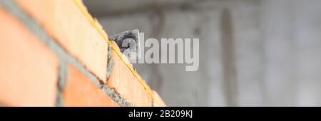 Mallet lying on top of brick wall as building and renovation Stock Photo