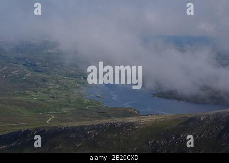 A view from the top of the Quinag mountain range, Scotland with mountain tops and sky Stock Photo