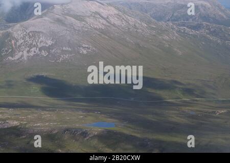 A view from the top of the Quinag mountain range, Scotland with mountain tops and sky Stock Photo